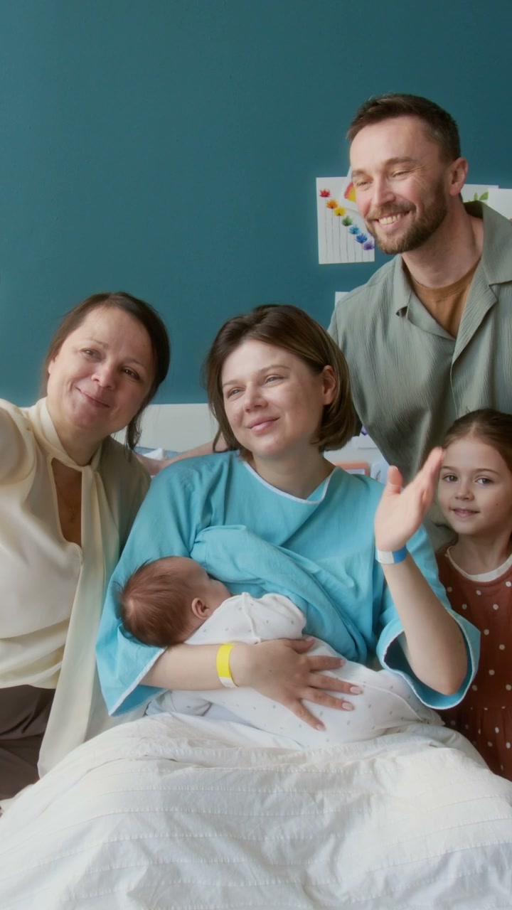 Family Visits New Mother and Baby in Hospital Room