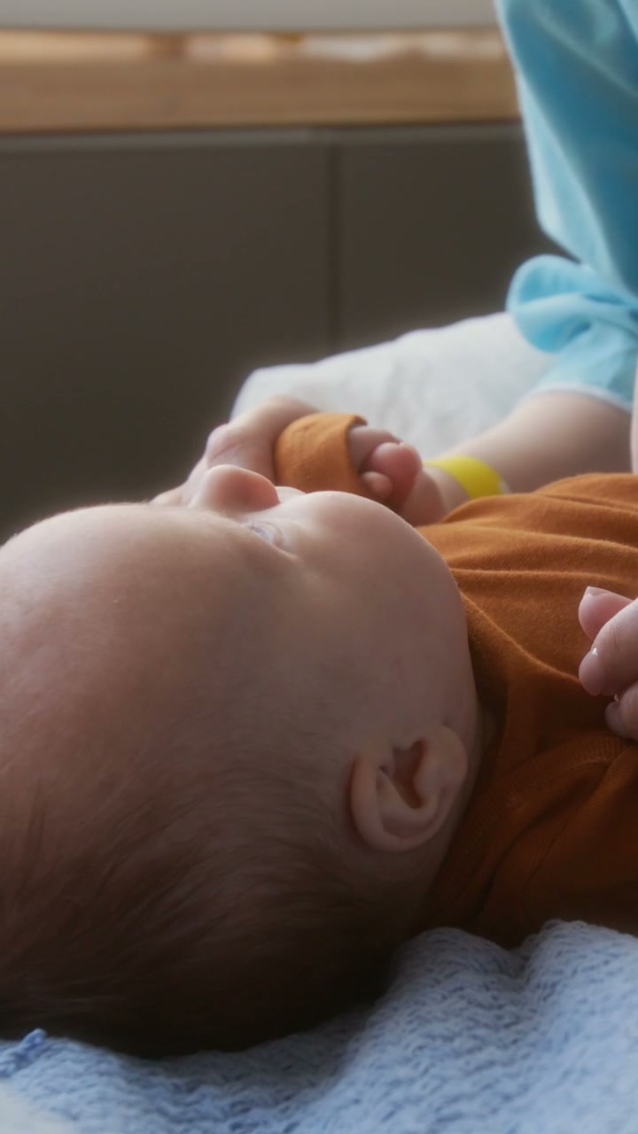 Newborn Baby's Hand Held by Parent