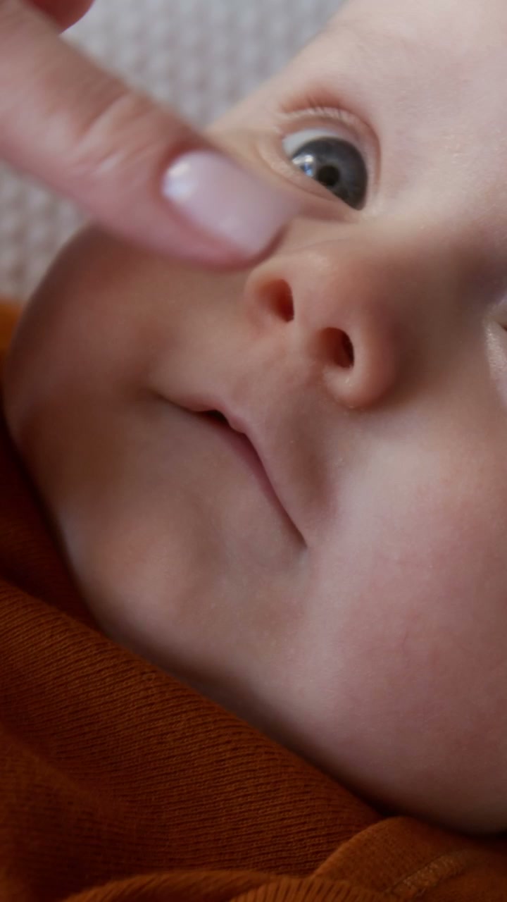 Gentle Touch on Newborn Baby's Nose