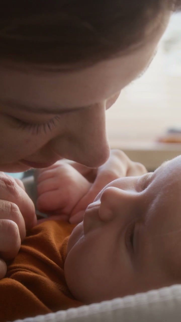 Mother Kisses Newborn Baby's Nose