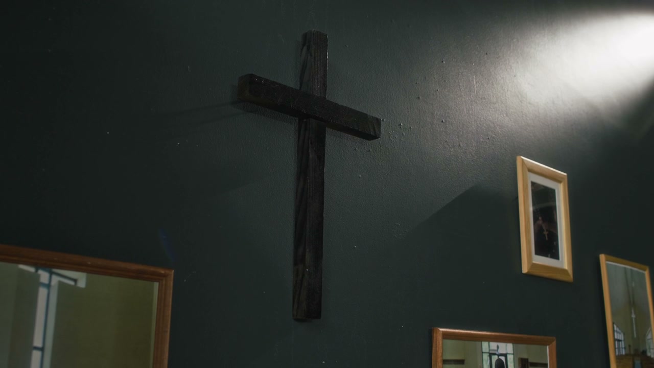 Wooden Cross on Dark Wall with Light