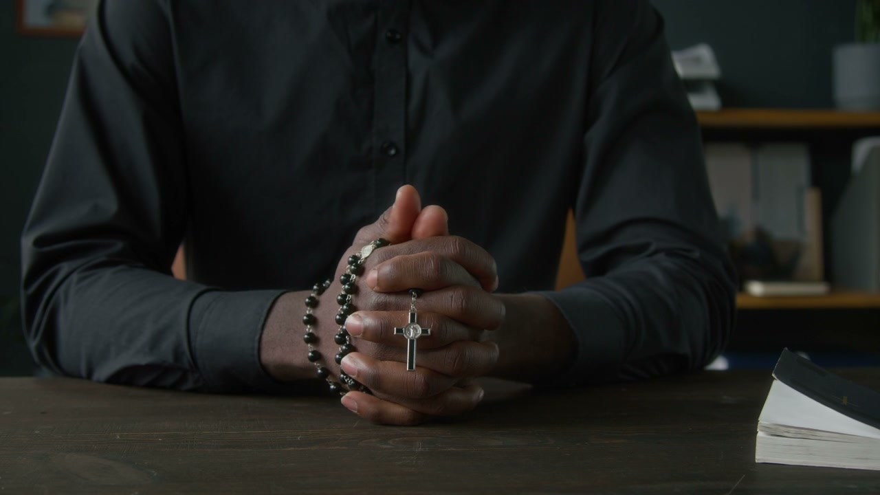Priest Praying with Rosary