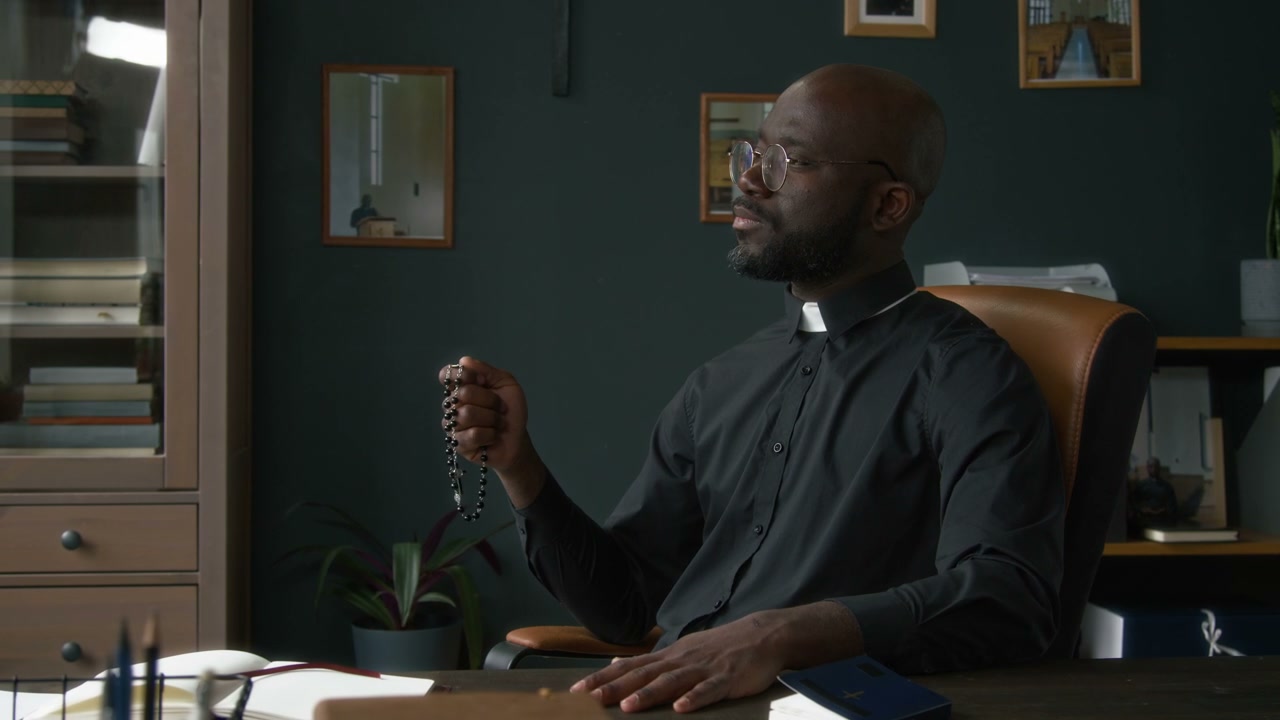Priest Contemplating with Rosary in Office