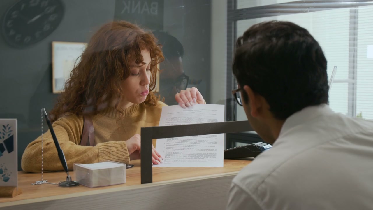 Woman Discussing Loan Agreement at Bank