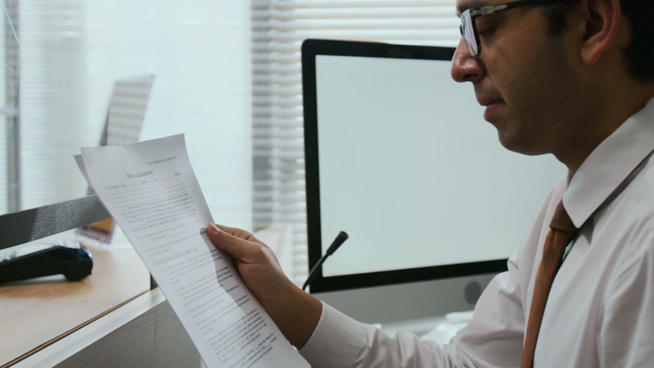 Financial Advisor Reviews Documents at Bank