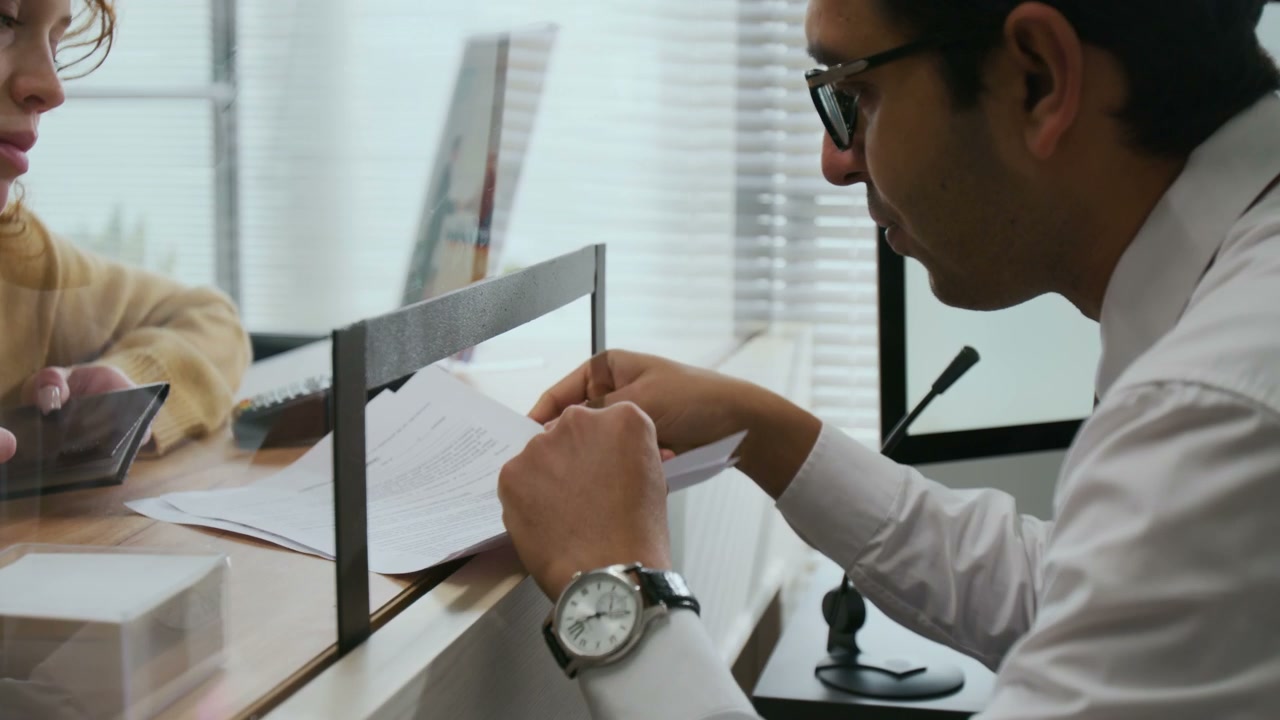Bank Employee Explaining Document to Customer