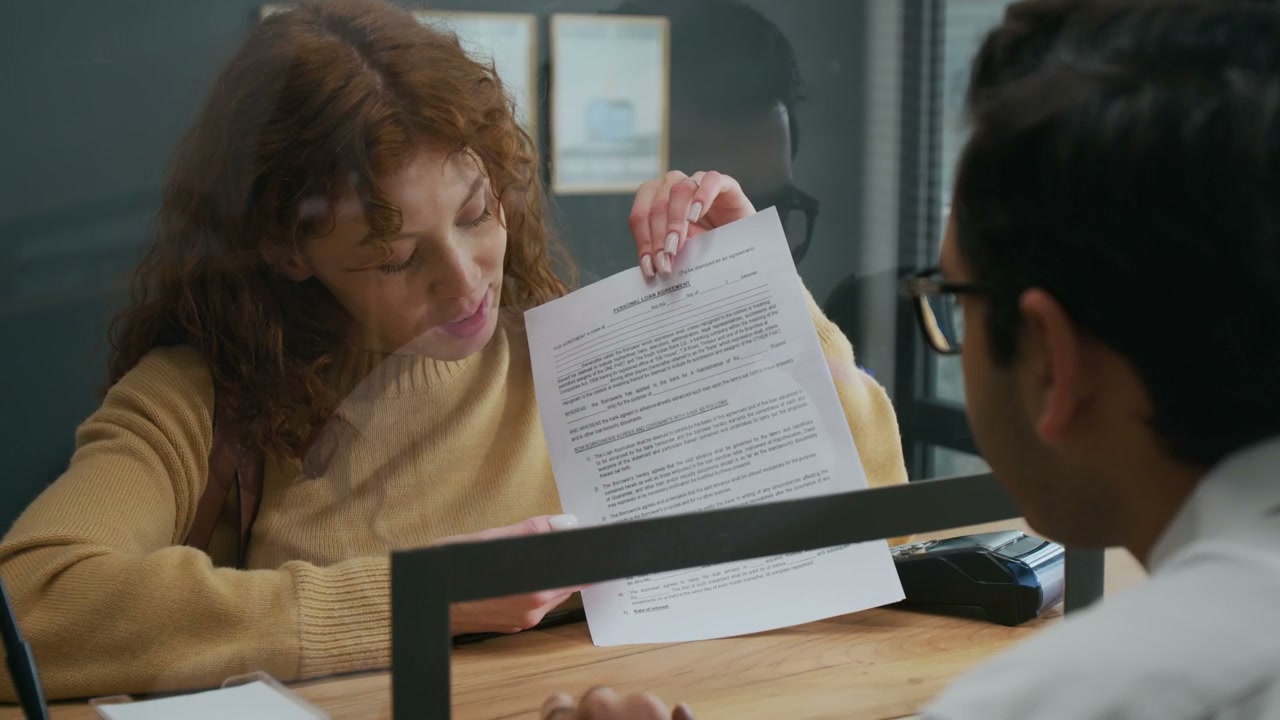 Woman Discussing Document with Financial Advisor