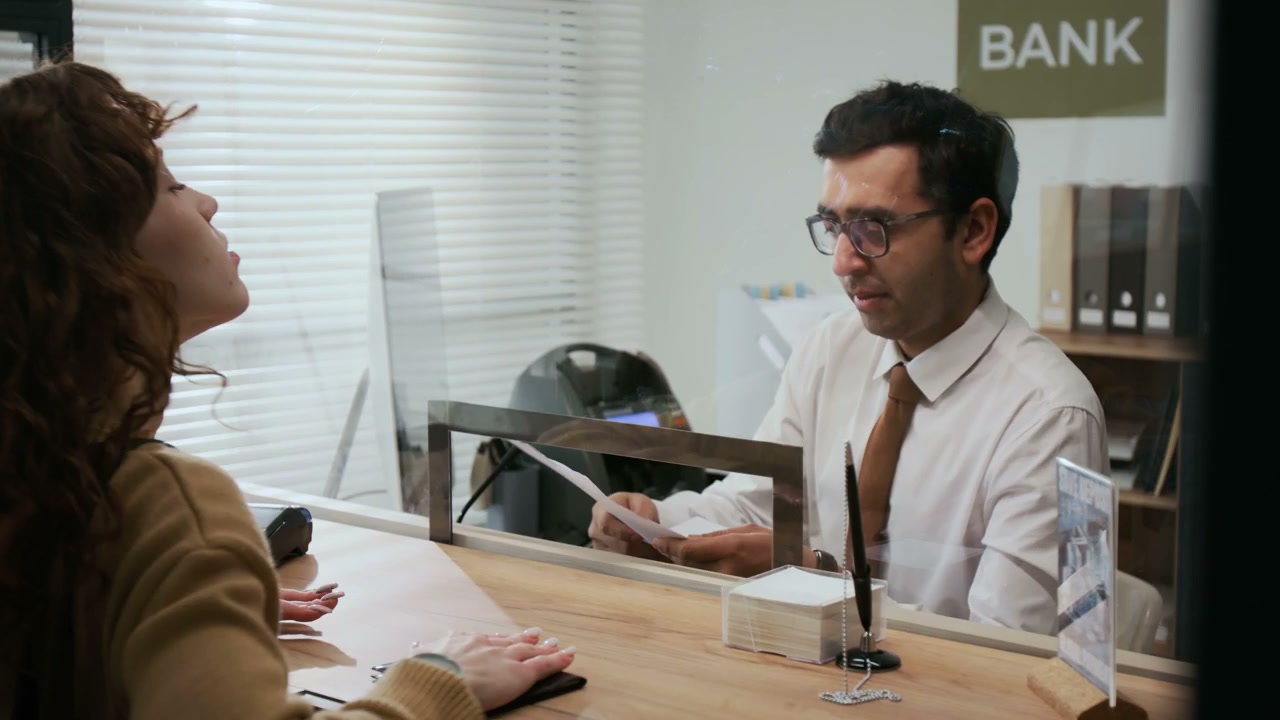Bank Employee Helping Customer with Documents