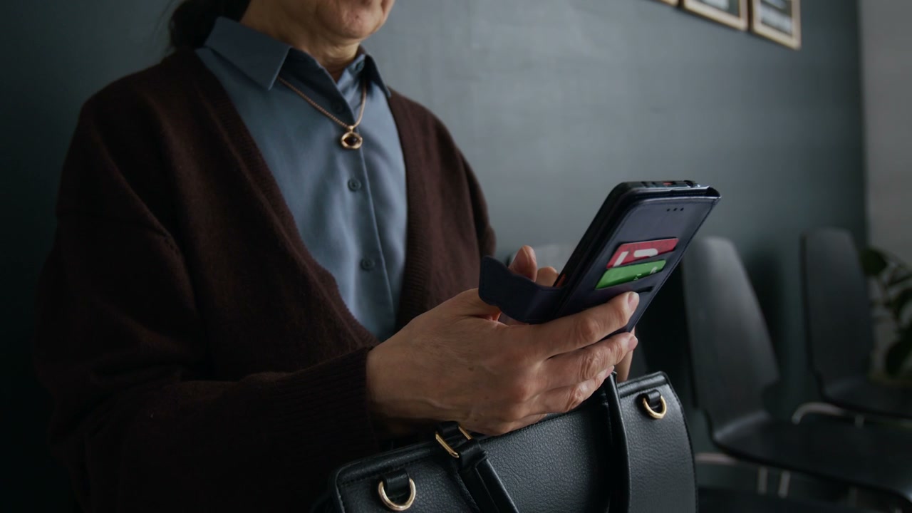 Older Person Using Phone in Bank Lobby