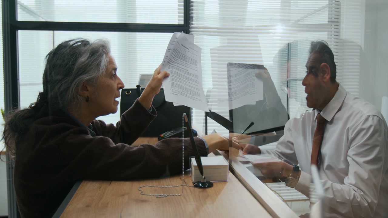 Elderly Client Arguing at Bank Counter