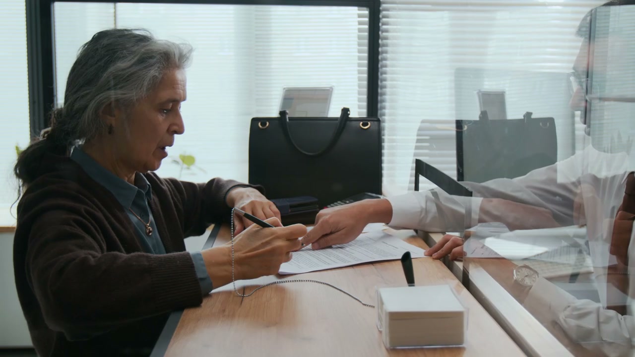 Customer Signs Documents with Bank Employee