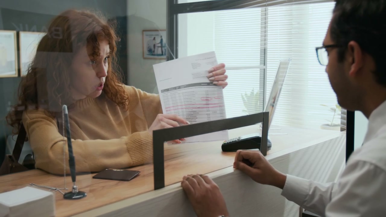 Upset Customer Discussing Document with Bank Employee