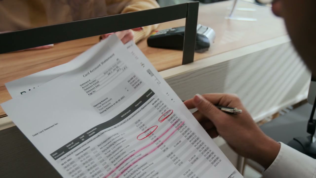 Unrecognizable Bank Teller Helping Confused Client Through Service Window