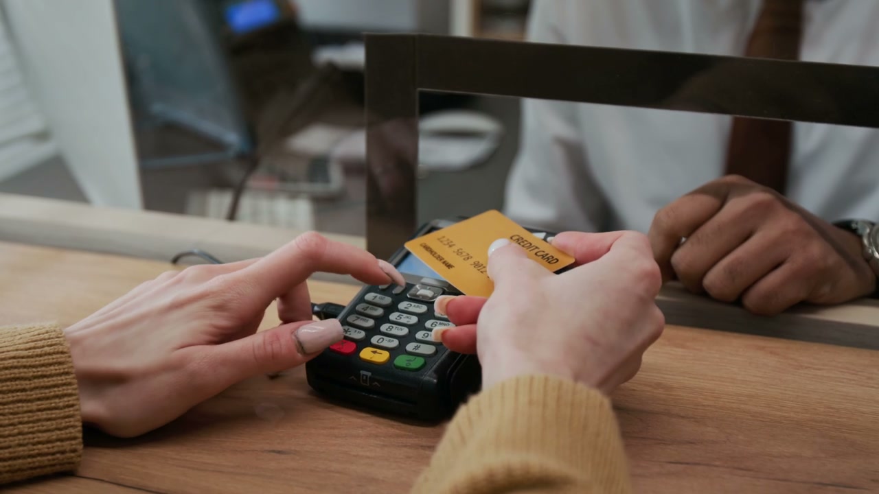 Customer Taps Credit Card on Payment Terminal
