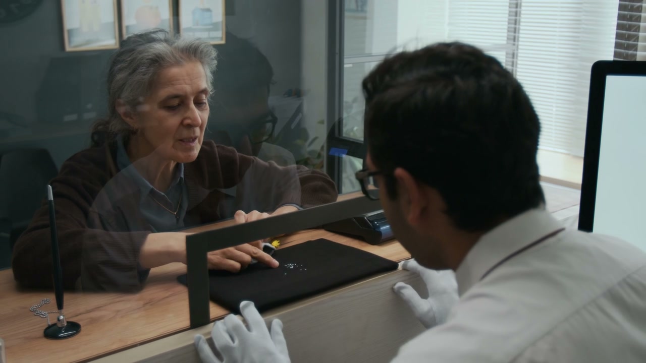 Gemologist and Client Examine Precious Stones