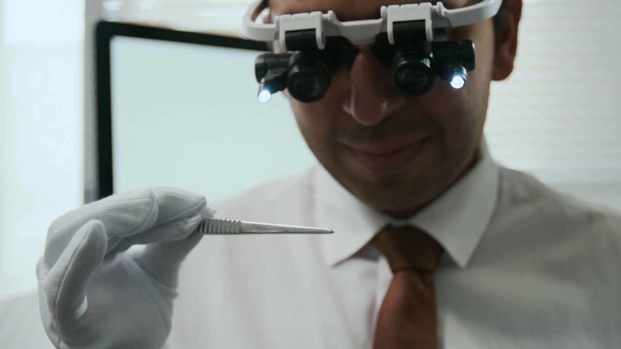 Expert Examining Diamonds With Magnifying Glasses
