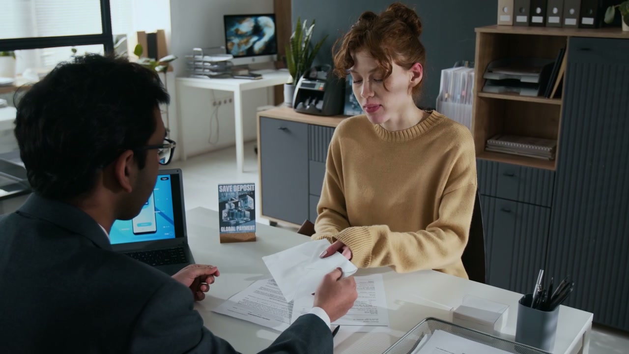 Client Receiving New Bank Card in Office