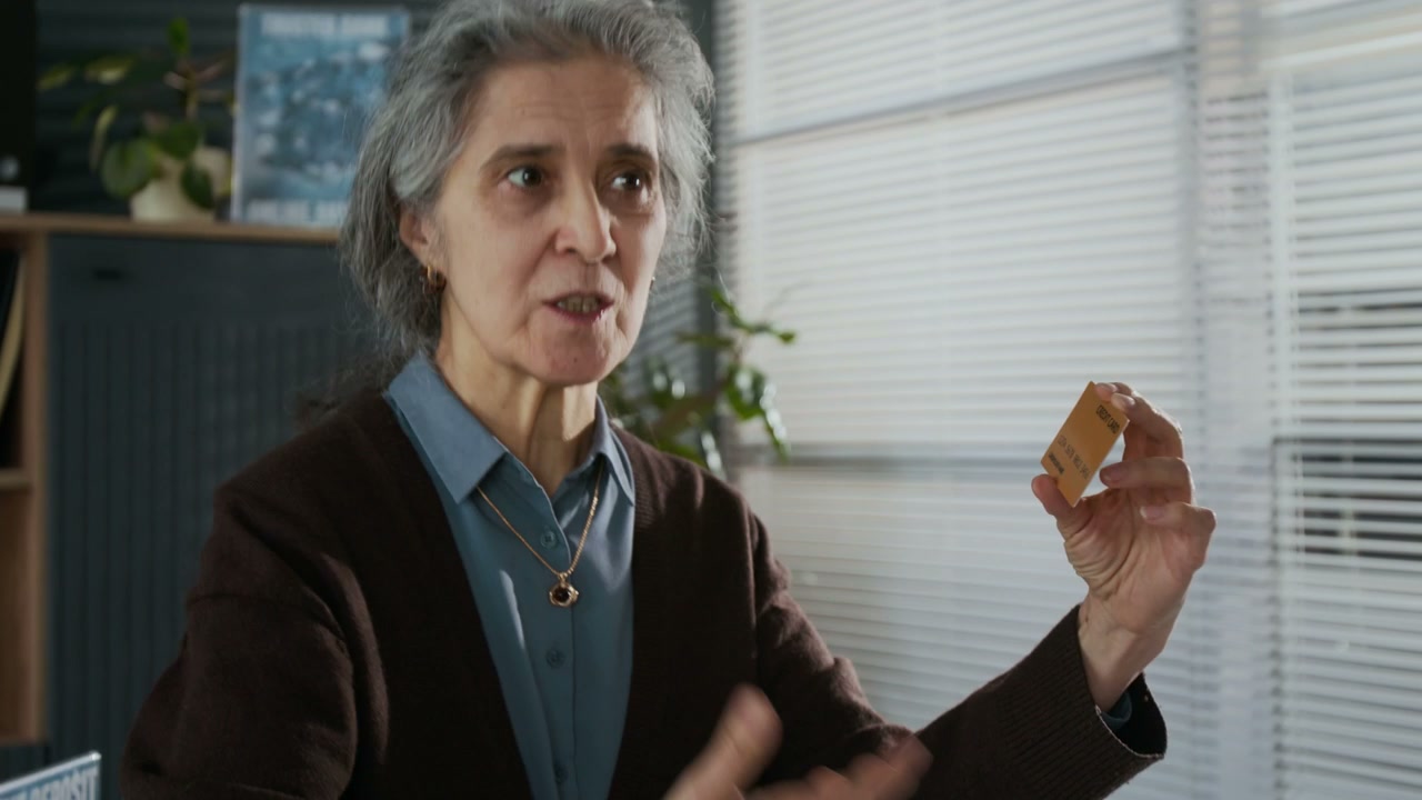 Senior Woman Holding Bank Card and Discussing