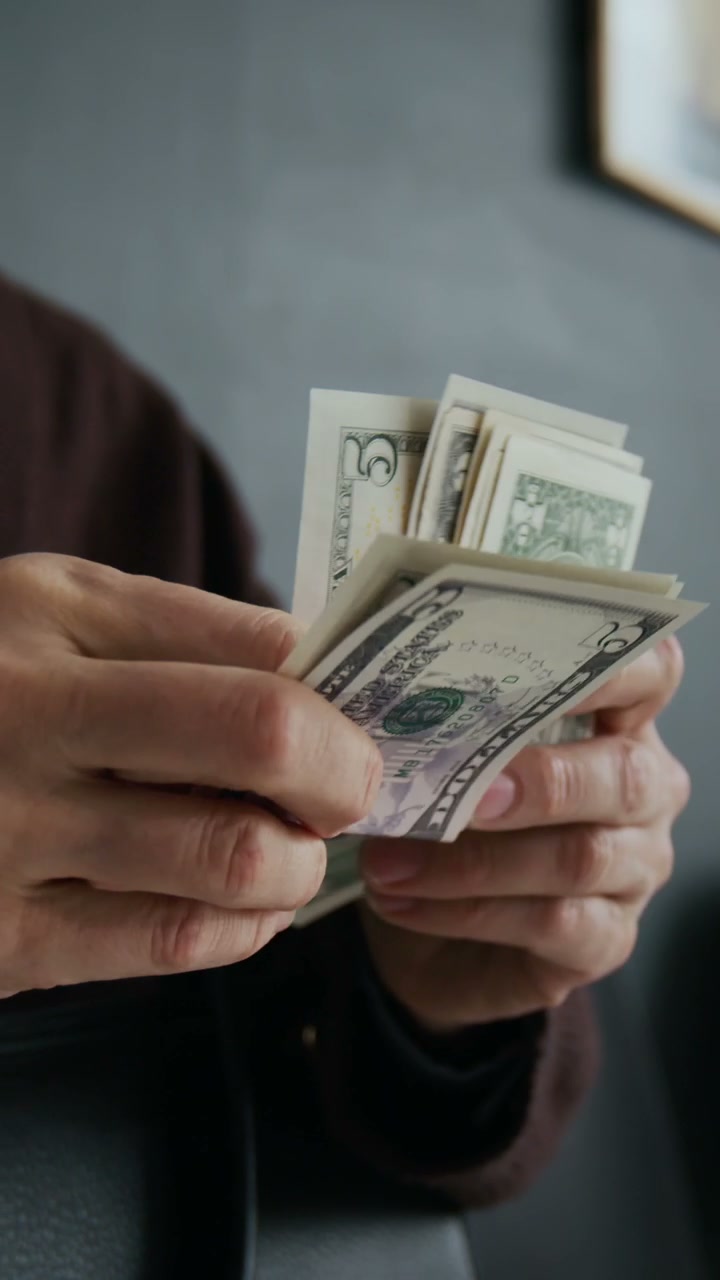 Hands Counting US Dollar Bills