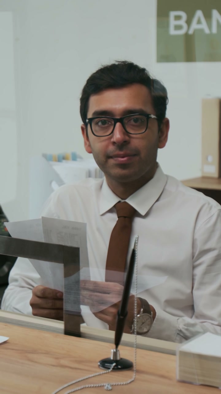 Bank Employee Looking at Camera
