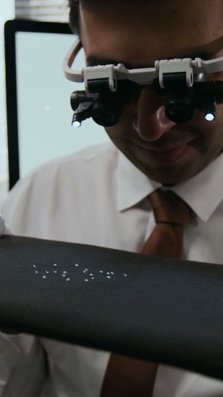 Gemologist Examining Diamonds with Magnifying Loupe