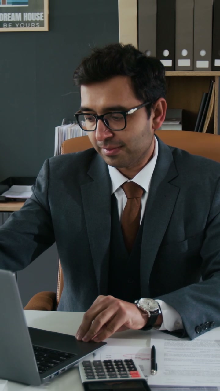 Professional Man Looking at Camera in Office