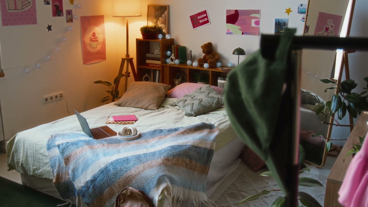 Cozy Teenager's Bedroom with Laptop on Bed