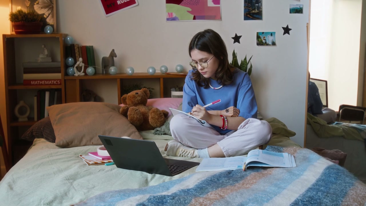 Teenage Girl with Prosthetic Arm Studies in Bedroom
