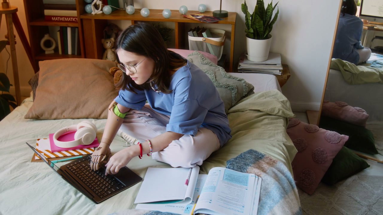 Teenage Girl with Prosthetic Arm Studying