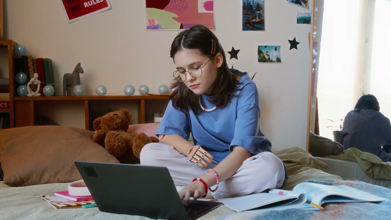 Teenage Student with Prosthetic Arm on Bed