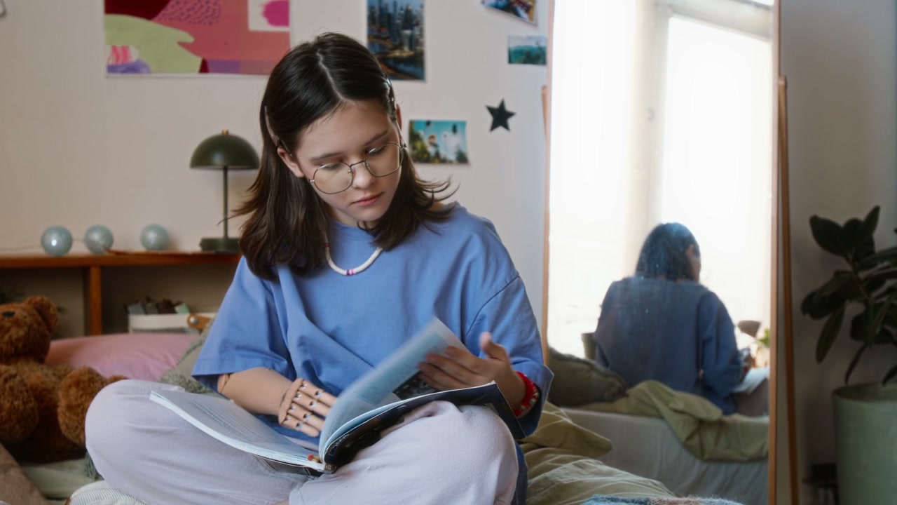 Girl with Prosthetic Arm Reading Book in Bedroom