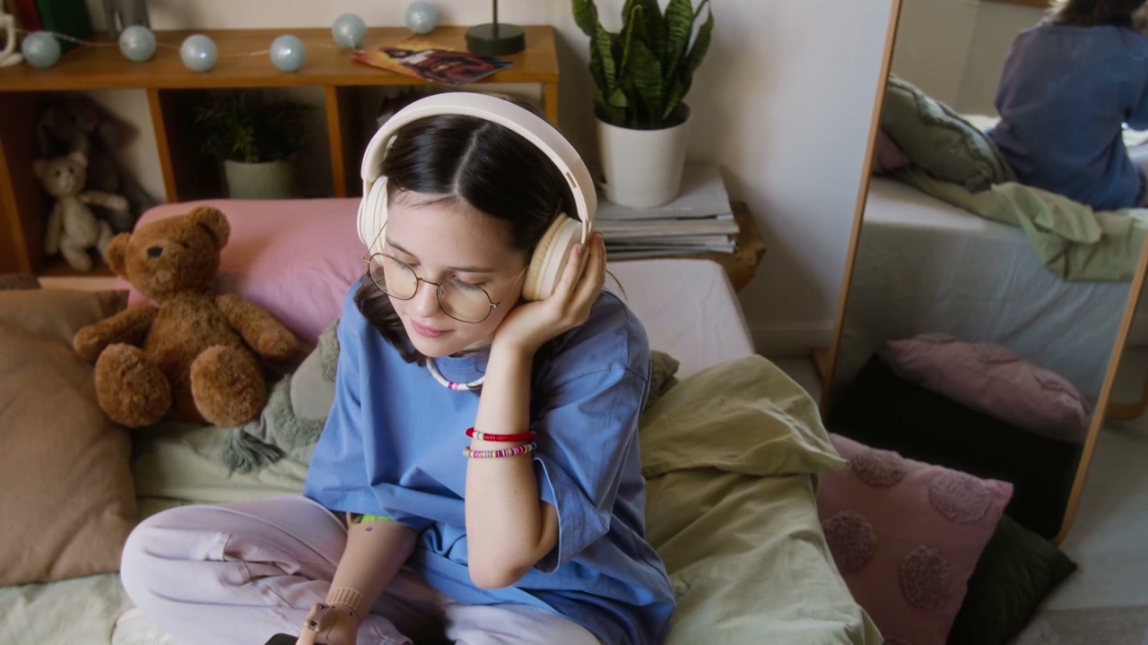 Teenage Girl with Prosthetic Arm Listening to Music