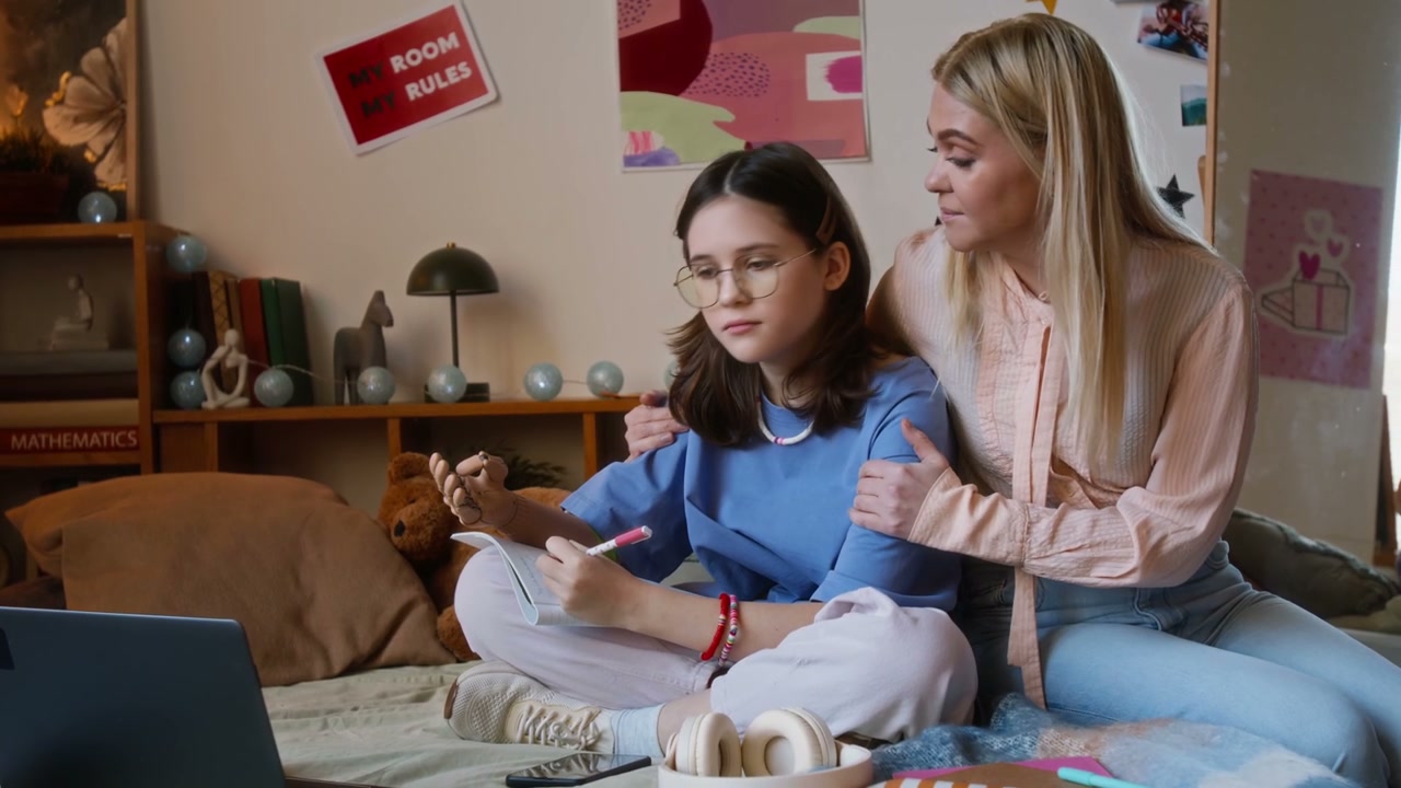 Mother and Daughter Studying in Bedroom