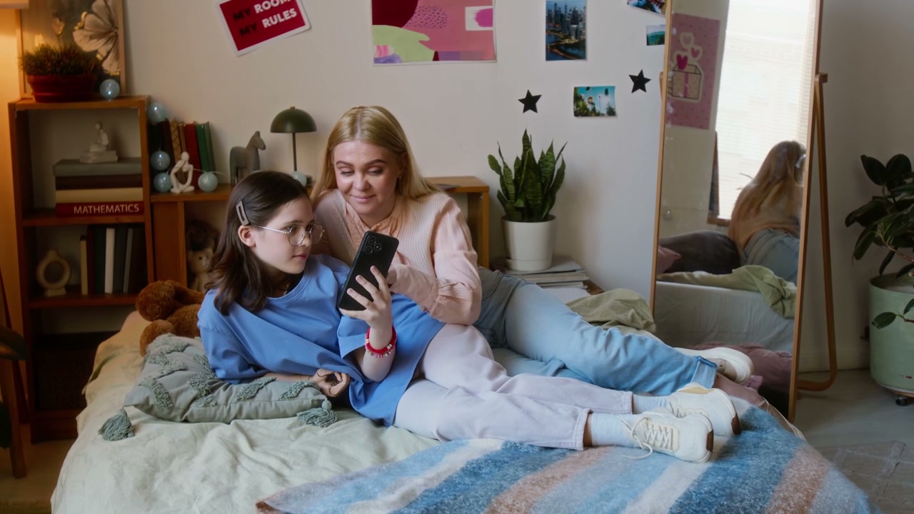 Mother and Daughter Relaxing with Smartphone