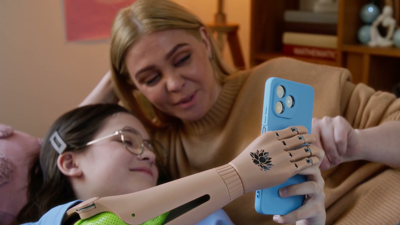 Mother and Daughter with Prosthetic Arm and Phone