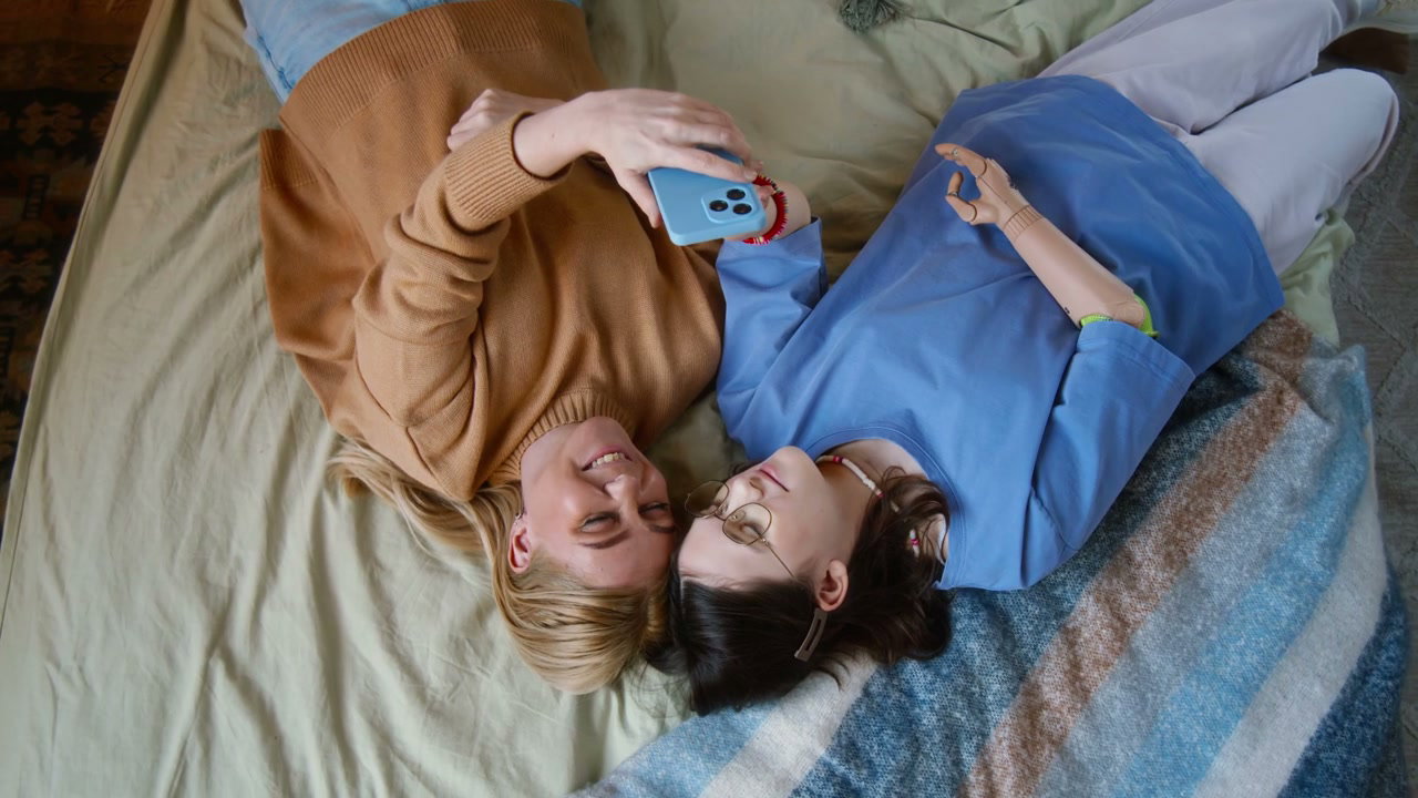 Mother and Daughter with Prosthetic Arm Using Phone