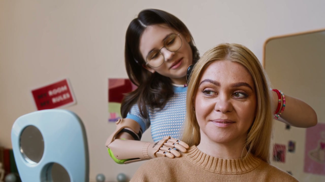 Daughter with Prosthetic Arm Brushes Mother's Hair