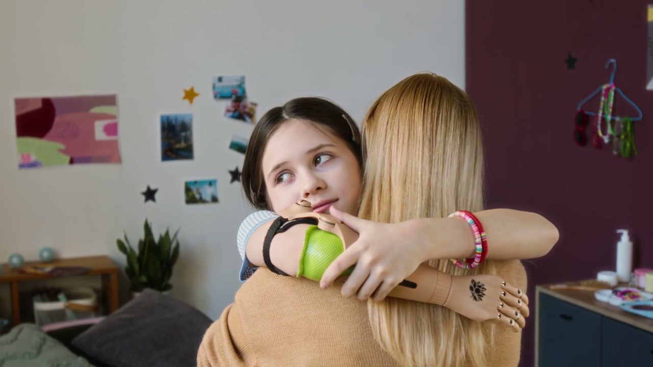 Mother and Daughter Hug with Prosthetic Arms