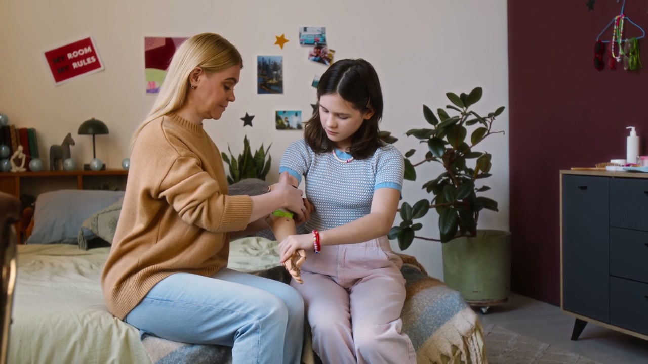 Mother Helps Teen Daughter Adjust Prosthetic Arm