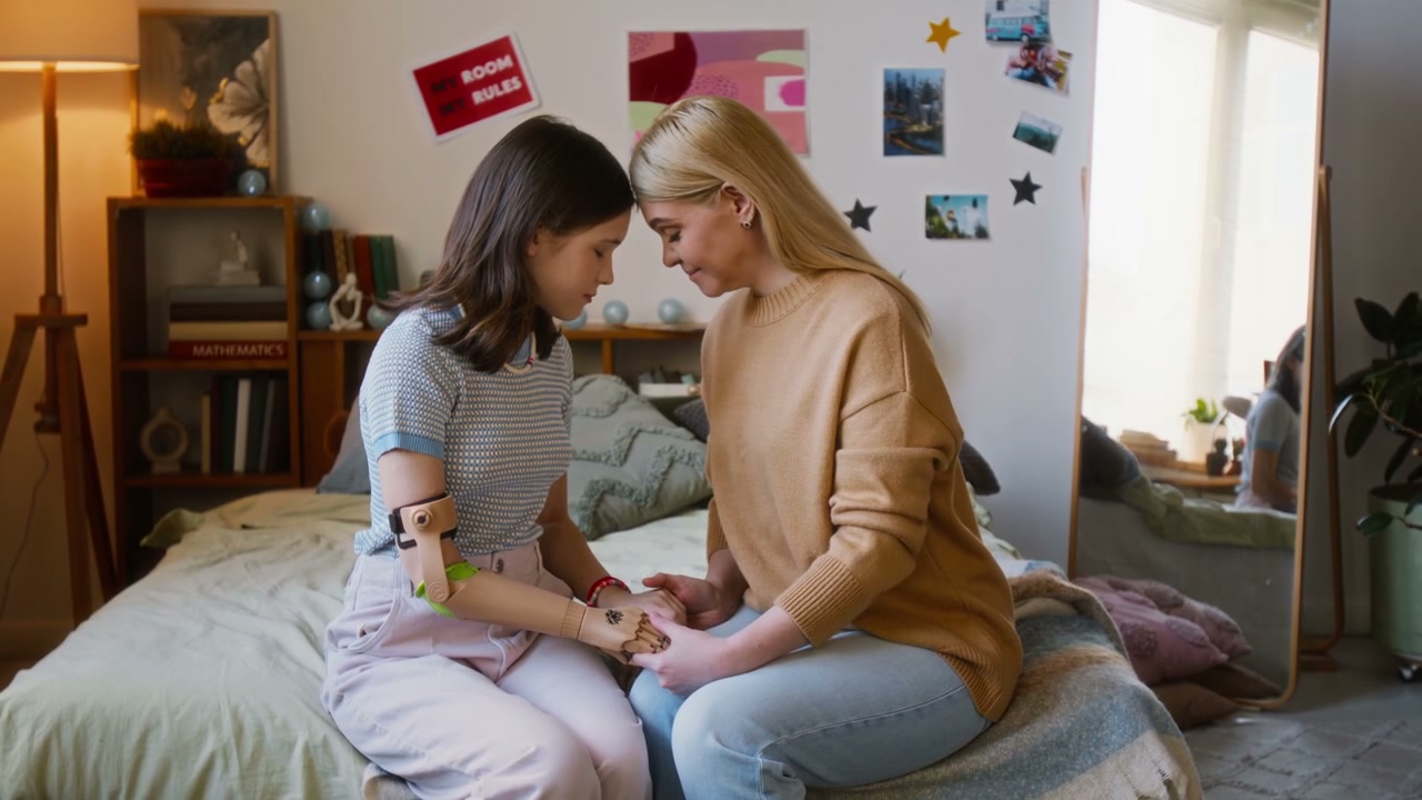 Mother and Daughter Connecting on Bed with Prosthetic Arm