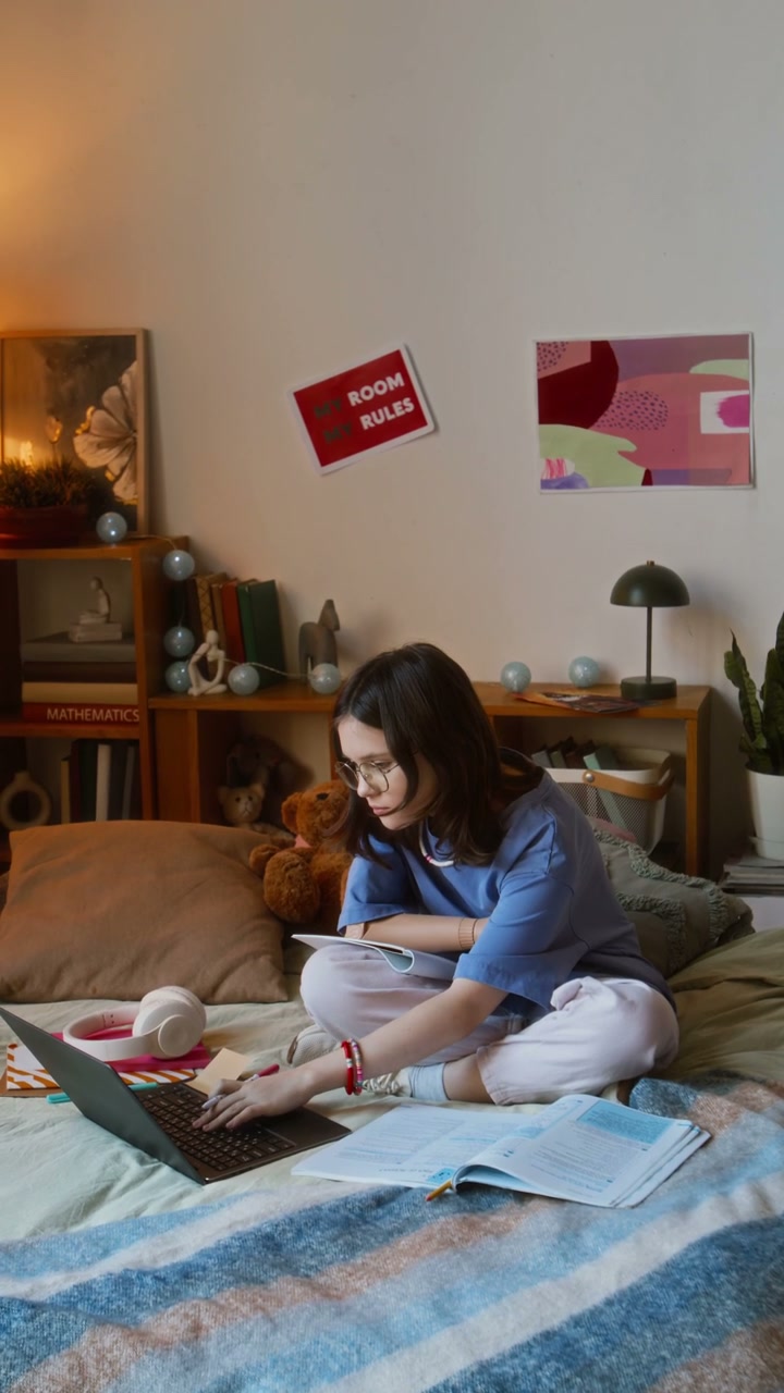 Teenager Studying on Bed with Laptop