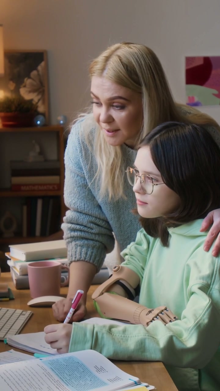 Mother and Daughter Studying with Prosthetic Arm
