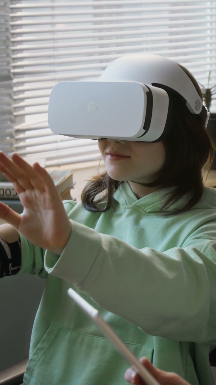 Young Girl with Prosthetic Arm Using VR Headset