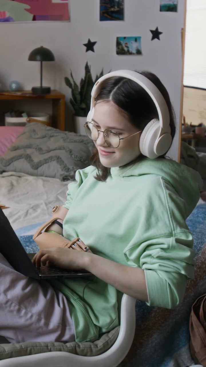 Young Woman with Prosthetic Arm Using Laptop