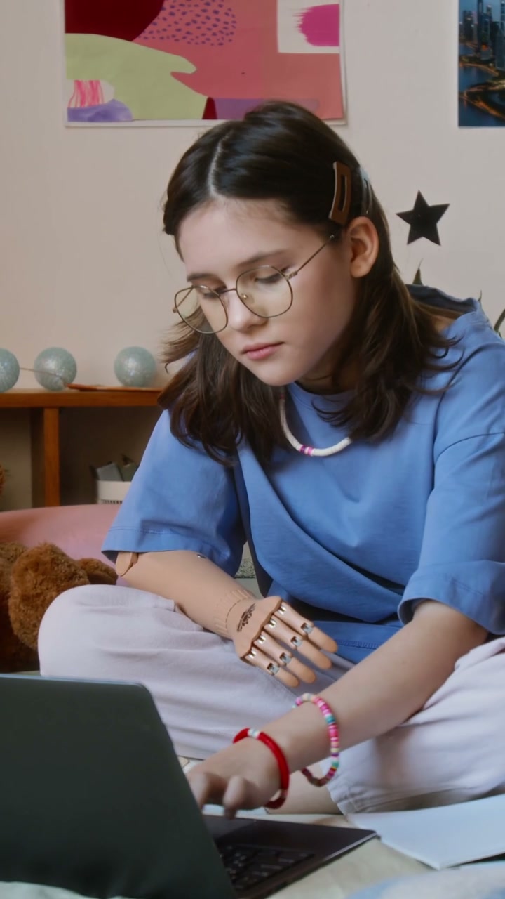 Teenage Girl with Prosthetic Arm Smiles