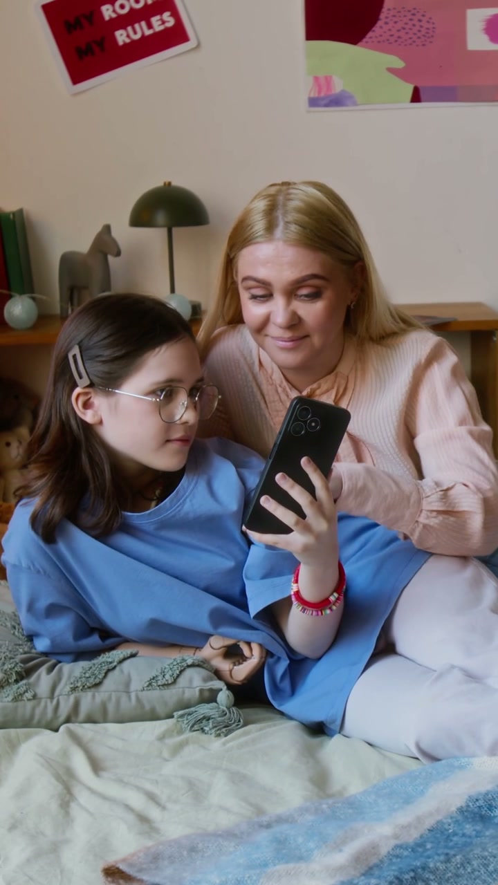 Mother and Daughter with Prosthetic Arm Share Phone