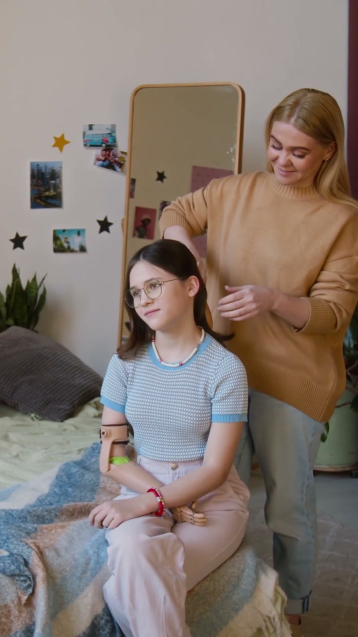 Mother Brushing Daughter's Hair with Prosthetic Arm