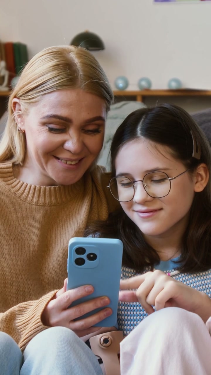 Mother and Daughter with Prosthetic Arm on Phone