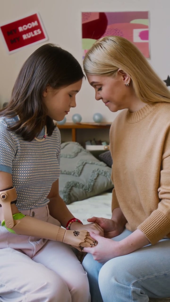 Mother and Daughter with Prosthetic Arm Connecting