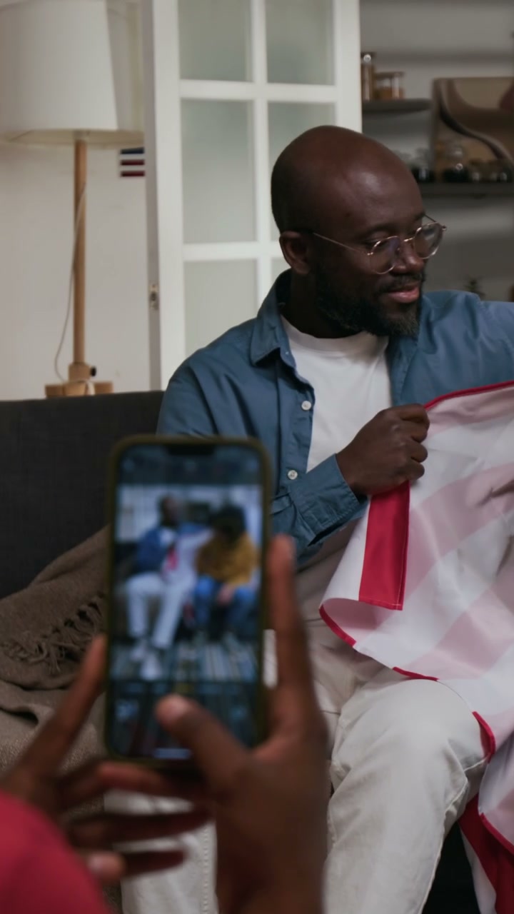 Taking Photo of Father And Son With American Flag